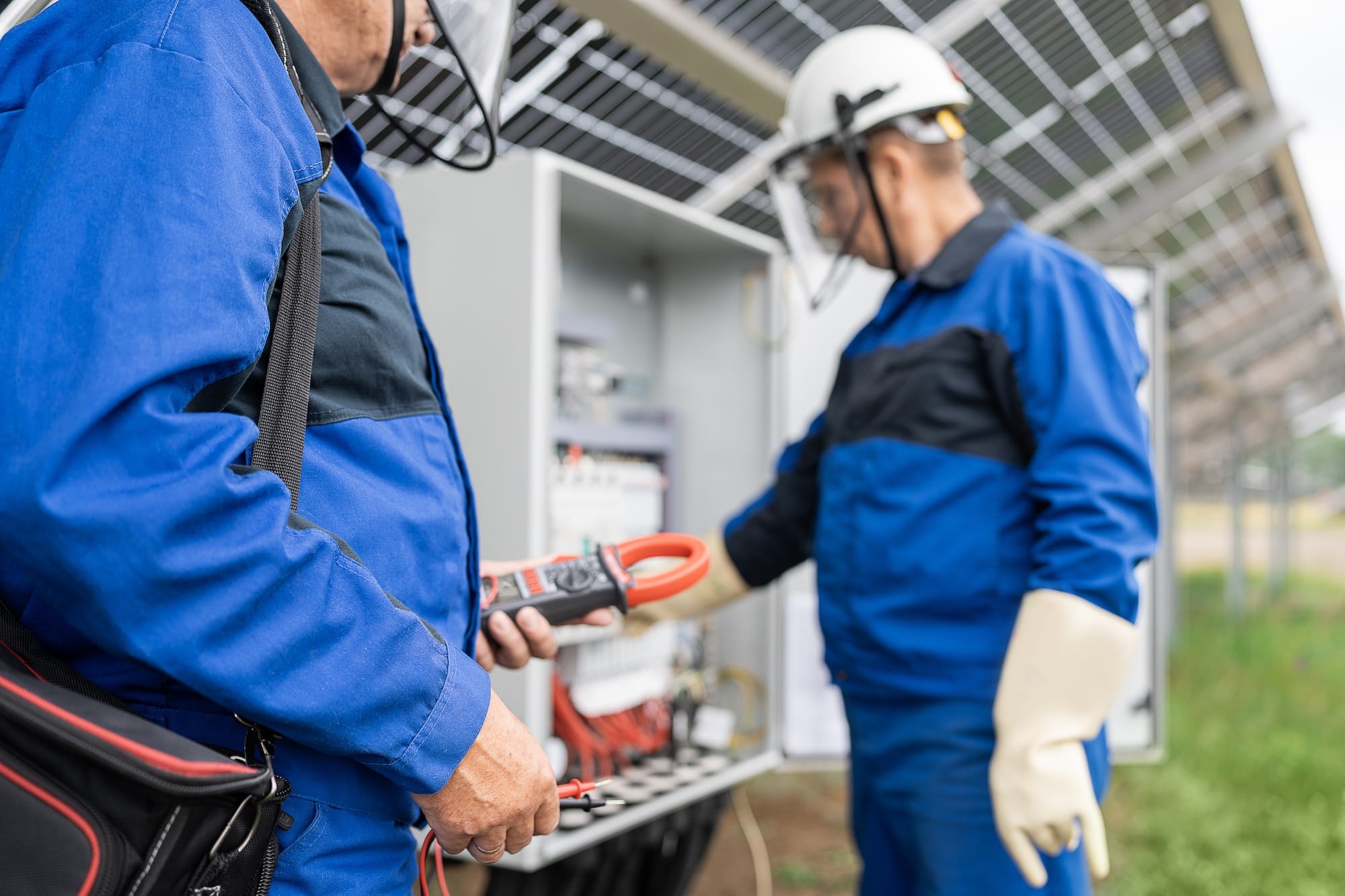 Two factory workers with electrical safety equipment